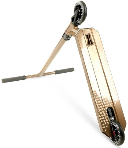 A Madd Gear Viral KAOS Complete Stunt Scooter - Ash lies on its side, displaying black wheels, a textured geometric-pattern foot deck, gray handlebar grips, and a visible underside with the rear brake.