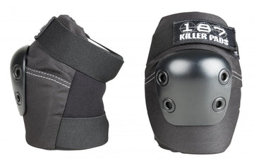 Two elbow pads in black, designed for skate protection, ensure high performance and safety with their hard, metallic dome. One pad is depicted from the side to showcase its adjustable straps that provide superior comfort, while the other pad is presented from the front displaying the "187" logo.