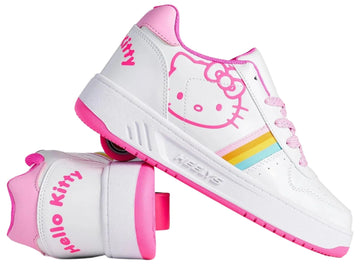 The Heelys x Hello Kitty Kama Girls Shoes in white and pink feature playful Sanrio Hello Kitty designs, rainbow side stripes, and "Hello Kitty" text on the heel; one shoe stands upright while the other shows the wheel.