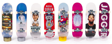 Tech Deck Olympic Competition Legends Fingerboards 8-Pack features eight unique boards with bold graphics—including a cityscape and "JAGGER"—celebrating legendary competitors and the spirit of the Paris 2024 Olympic Games.