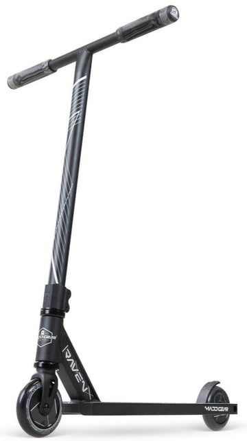 The Madd Gear MG 1 Raven Complete Stunt Scooter in Black/Black features a T-shaped handlebar, angled stem stripes, and a slim "VADER" deck for lightweight performance. It stands upright on a white background.