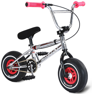 The Wildcat OG 3A Mini BMX Bike - Galaxy Red by Wildcat features thick black PRO Street 65PSI tyres, CNC aluminium red rims, black pedals and seat, and pink handlebar grips. Shown against a white background.