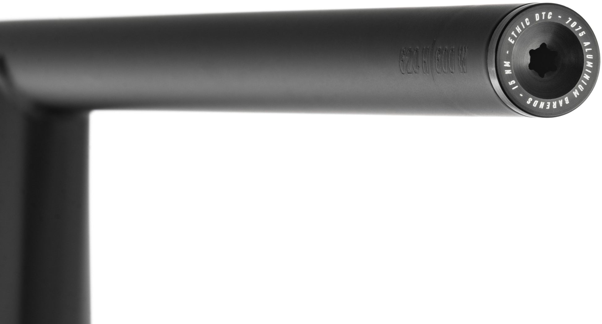Close-up of the Ethic Flush Aluminium Stunt Scooter Bar Ends in black, showcasing a visible bolt head at the end of the black metal handlebar. The bar end is engraved to indicate it is crafted from 7050 aluminum, highlighting its durable and stylish design by Ethic. The background is white.
