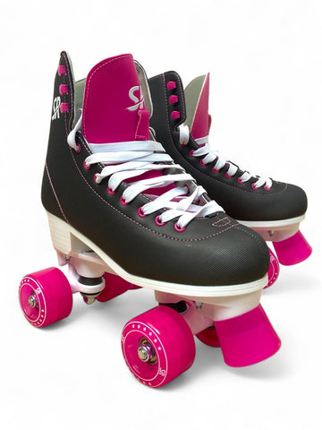 The Supreme Malibu Quad Roller Skates - Black / Pink by Supreme feature black and pink uppers, white laces and soles, plus bright pink wheels and toe stops—ideal for outdoor fun, shown on a plain white background.