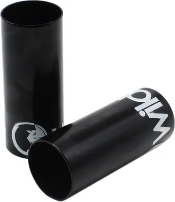 Two Wildcat Basic Steel Mini BMX Pegs in black, featuring white graphics, are shown on a white background—one standing upright and the other lying on its side. These chromoly pegs are designed for mounting on BMX axles.
