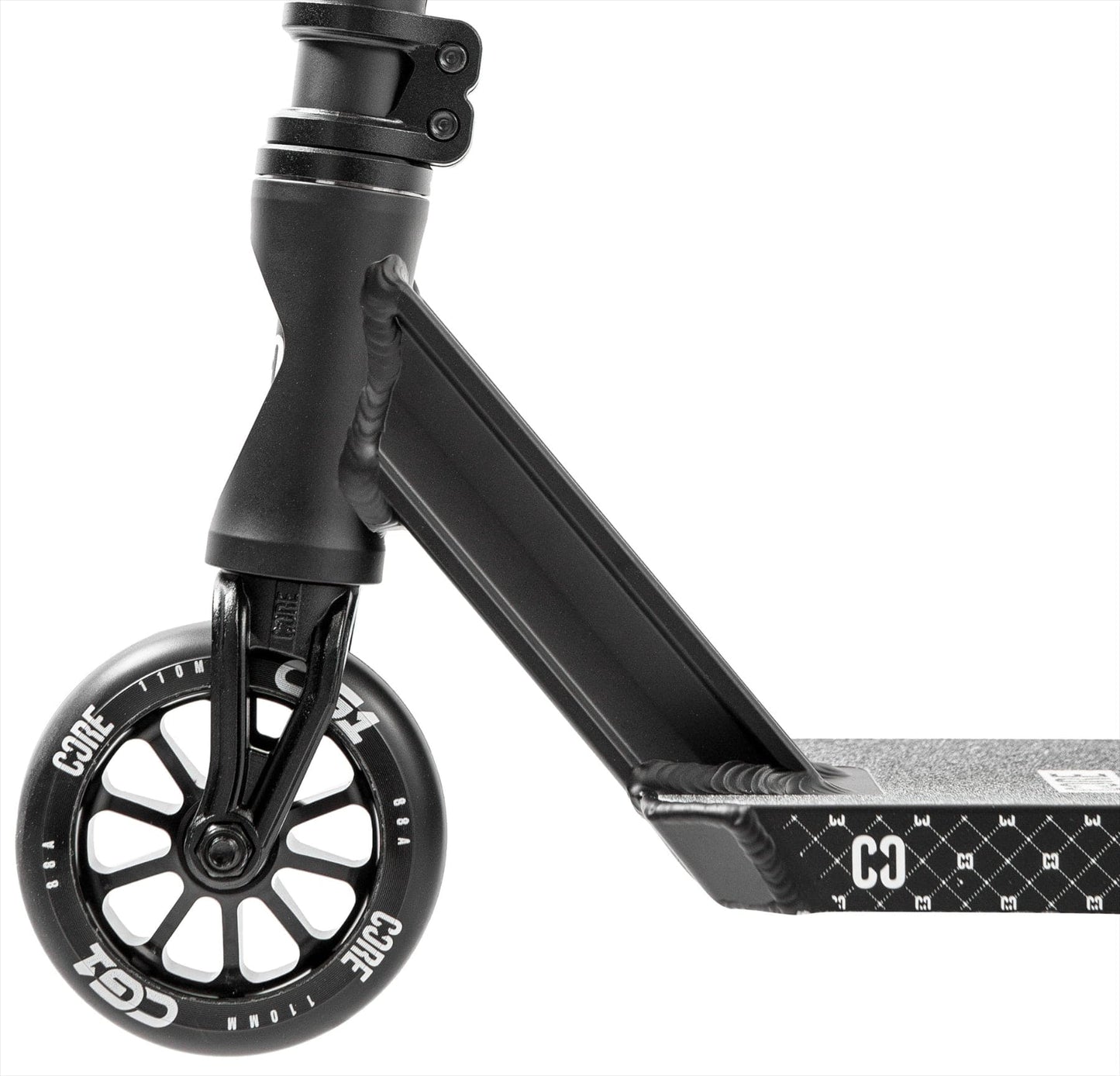 Close-up of the CORE CG1 Complete Stunt Scooter - Black by CORE, highlighting the textured diamond-patterned deck, sturdy fork, and wheel featuring "CORE" in white letters.