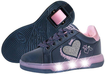 The Breezy Rollers Blast Shoes - Purple by Breezy Rollers feature purple uppers with pink accents, glitter heart designs, and light-up soles. One shoe is upright while the other shows the patented wheel system in these fun wheeled sneakers.