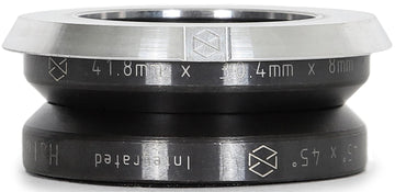 A close-up of the Native Halo Integrated Stunt Scooter Headset - Raw by Native, featuring engraved "41.8mm x 30.4mm x 8mm" measurements, a geometric logo, black body with silver top edge, and SCS setup compatibility.