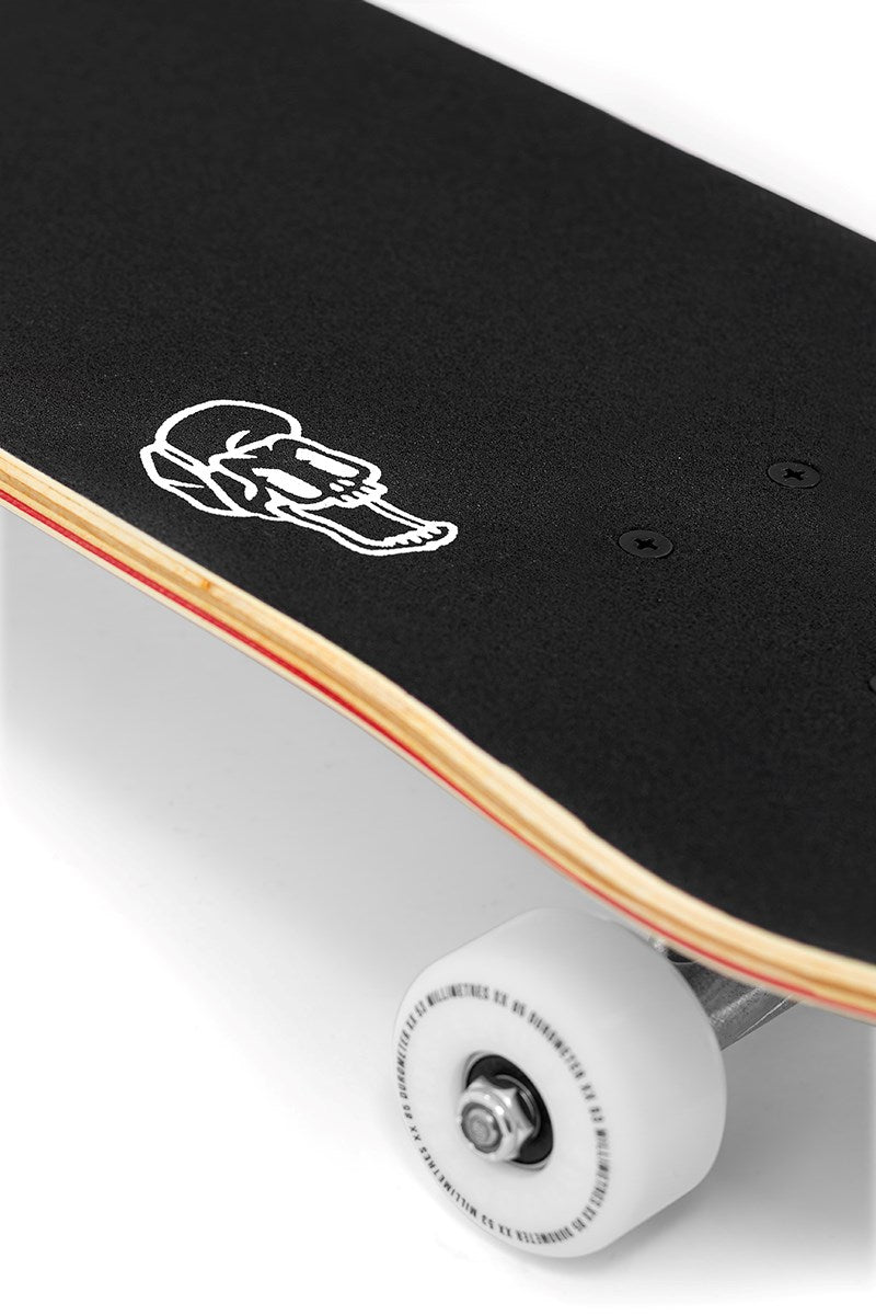 Close-up of the Enuff Meltworld Confused Complete Skateboard (7.75" x 31.5") by Enuff, featuring black grip tape, a white skull graphic on the deck, and white wheels—perfect for beginner skaters.
