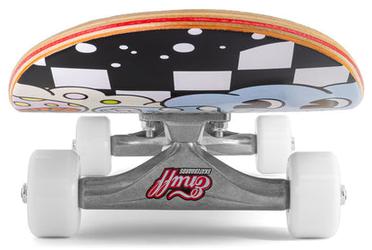 A ground-level close-up of the Enuff Meltworld Dazed Complete Skateboard (7.75" x 31.5") displays white wheels, Gullwing trucks, and a maple deck with bold black, white, and blue graphics—perfect for beginner riders.