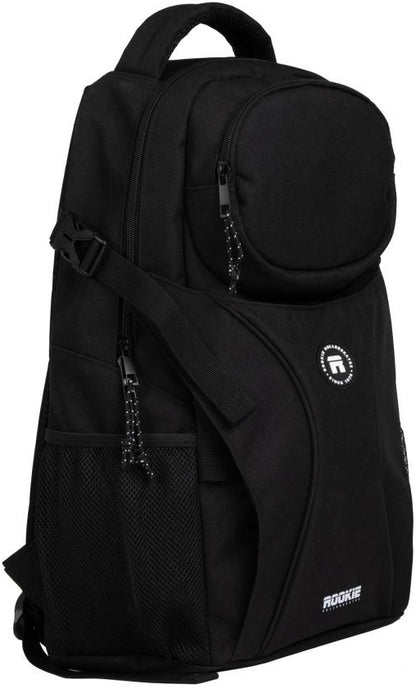 Introducing the Rookie Skatepack Classic 78 25 L Backpack in black. This versatile skate backpack by Rookie features a spacious main compartment, a round top pocket, a front zipper pocket, and a mesh side pocket—all with sleek black zipper pulls. Adjustable straps ensure comfort, while the iconic “Rookie” logo on the lower front highlights its signature style.
