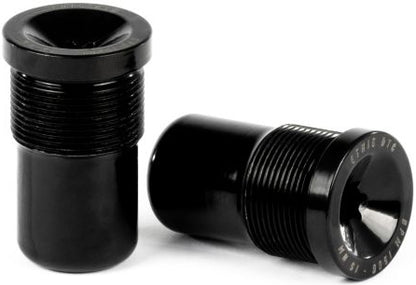 Two black cylindrical metal objects with threaded midsections are displayed—one upright, the other lying horizontally to reveal engraved text on its flat end. Both feature a flared rim and a glossy, smooth finish. These Ethic DTC Handlebar Balance Point Modulation - 150g bar ends by Ethic are expertly crafted to provide riders with exceptional durability and precise balance point modulation.