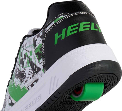 A close-up of the heel of the Heelys x Minecraft Kama Boys Shoes in white, black, and green shows a green wheel in the sole and bold green "HEELY" branding on the black heel.