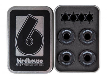 Open metal box featuring Birdhouse ABEC 7 Black Skateboard Bearings - 8 Pack. The left side prominently displays the Birdhouse logo and text, while the right side securely houses eight premium skateboard bearings in a protective foam insert.