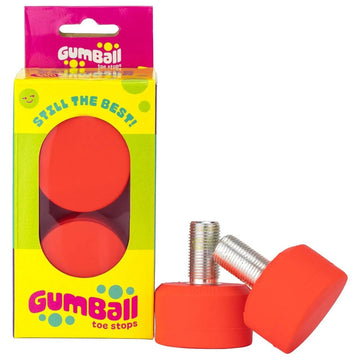 The packaging features two Gumball Roller Skate Long 30mm 83A Toe Stops in bright orange. A vibrant yellow and pink design says "Still the Best!" and "Gumball Toe Stops." The unique rubber blend promises great stopping power on any surface.