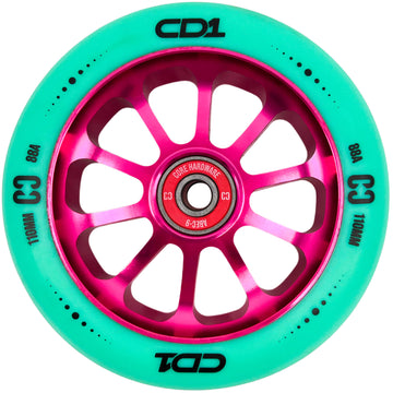 The CORE CD1 110mm Stunt Scooter Wheel - Teal / Pink features a metallic pink multi-spoke hub and teal rubber with “CD1,” “C3,” “88A,” and “110MM” in black. The bearing is visible at the center. Brand: CORE.