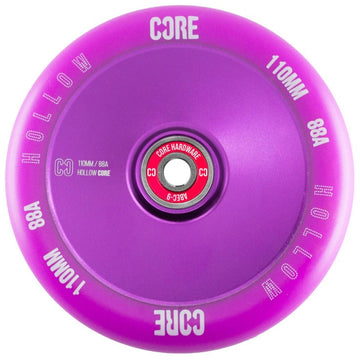 Introducing the CORE Hollow Core V2 110mm Stunt Scooter Wheel in Purple, this vibrant wheel showcases a sleek hollow core design with the engraved text "CORE," "HOLLOW," "110MM," and "88A." Its central bearing is adorned with striking red color and white text, engineered to ABEC-9 standards for ultimate performance.