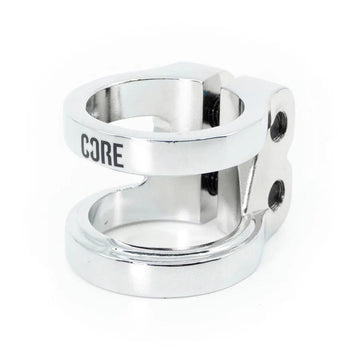 The CORE Venom 2 Bolt Oversized Stunt Scooter Clamp - Chrome is a CNC machined aluminum clamp from CORE, featuring an engraved "CORE" logo on its sleek surface. Its cylindrical design includes smooth, polished chrome surfaces with two screws and circular openings, offering a balance of strength and lightweight functionality.