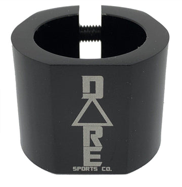 The Dare Warlord 2 Bolt Standard Stunt Scooter Clamp in black, crafted by Dare, is a CNC machined, lightweight metal clamp featuring a hexagonal shape with an engraved "Dare" name and a slit for tightening. It offers exceptional grip and durability, making it perfect for extreme sports enthusiasts.
