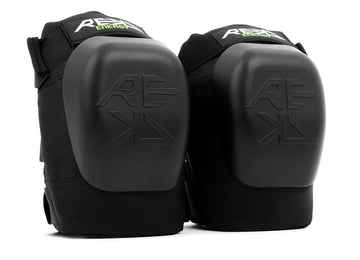 The REKD Energy Patrol Ramp Knee Skate Protection Pads in black are ideal for extreme sports. Featuring the REKD logo and hard plastic impact caps, these pads offer reliable knee protection with adjustable straps, perfect for activities like skating or biking.