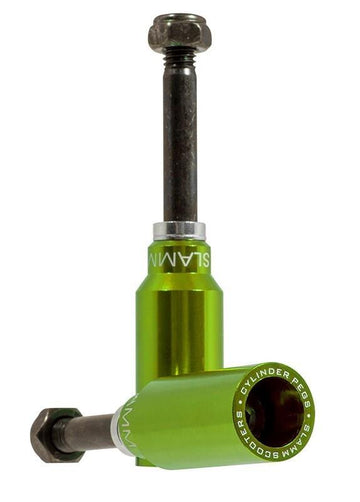 Two green Slamm Cylinder Stunt Scooter Pegs are shown in an L shape—one upright, one lying flat—with branded text from Slamm visible around the circular end. Bolts are also included.
