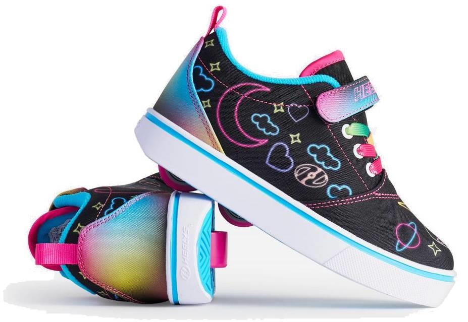 Two Heelys Pro 20 Prints X2 Girls Shoes by Heelys in Black/Hot Pink/Multi, featuring neon heart, star, and planet designs. One shoe is upright; the other shows a pink, teal, and yellow gradient heel and white soles.