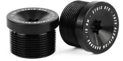 A pair of Ethic Flush Aluminium Stunt Scooter Bar Ends in black, featuring threaded exteriors and the engraved text "ETHIC DTC 7075 ALUMINIUM BARENDS 15 NM" around the top edge—premium bar ends by Ethic, shown standing and lying down on a white surface.