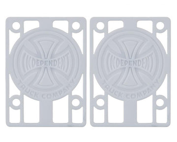 A pair of white skateboard risers featuring the "Independent Truck Company" logo with a cross design. The Independent Skateboard Riser Pads, measuring 1/8", have multiple slots for mounting and are perfectly compatible with Indy trucks.