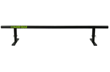 Set against a white background, the Madd Gear MGP Fifty5 Grind Rail - 140cm beckons skaters to execute daring grind tricks. This sleek black rail features a green Madd Gear logo on its left side and is supported by two sturdy legs with flat bases, ensuring ultimate stability for skaters to showcase their skills.
