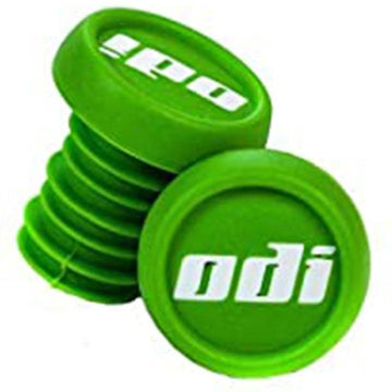 A set of ODI Push-In Stunt Scooter Bar Ends in green features the brand's name "odi" in white. One bar end is positioned upright, while the other is slightly angled, showcasing their ribbed structure and resin material for a secure fit and customizable scooter bar experience.