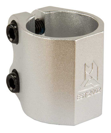 Close-up of a Madd Gear MGP MFX Extreme 2 Bolt Oversized Stunt Scooter Clamp, expertly crafted from durable alloy in silver. The clamp showcases strong clamping power with two black screws and is adorned with a geometric logo along with the text "EST 2002.