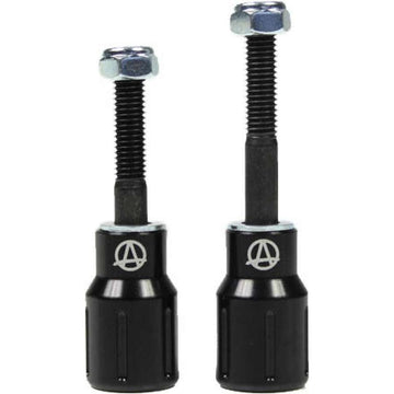 Two black Apex Barnaynay motorcycle bar end sliders with silver bolts on top. The sliders display a logo featuring an "A" inside a circle. They vary in height, one slightly taller than the other, reflecting Kiall Barnes's design precision.