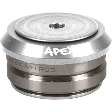 Close-up of a raw silver Apex Integrated Stunt Scooter Headset, showcasing a round top with the brand’s engraved logo. Designed for scooters, this headset features a stack of metal components and a central hole on its surface, echoing the sleek construction typical of integrated scooter decks.
