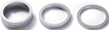 Three chrome rings of different thicknesses are lined up on a white background, resembling headset spacers. Each is labeled with distinct measurements: "H10mm," "H5mm," and "H3mm." These Blunt Envy Scooter Headset Spacers in Chrome are perfect for customizing your Blunt Envy stunt scooter setup.