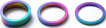 A row of Blunt Envy Scooter Headset Spacers in Oil Slick Neochrome, featuring a metallic finish that smoothly transitions between shades of blue, purple, and green. These spacers come in varying widths of 10mm, 5mm, and 3mm, perfect for customizing your stunt scooter.