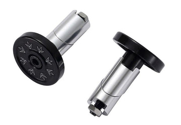Two Blunt Envy Alloy Scooter Bar Ends in chrome silver, featuring engraved arrow designs, are crafted for scooters. These cylindrical weights come with threaded bolts for easy attachment. One stands upright, while the other is positioned on its side to highlight the expandable design of the compatible bar ends.