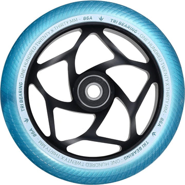 A close-up of a Blunt Envy Tri-Bearing 120mm x 30mm scooter wheel in teal and black highlights its sophisticated Tri-Bearing design and intricate spoke pattern. The tire, labeled "120x30mm" with an "86A" hardness rating, features a 30mm wide profile for enhanced control. Its center hub is sleek, black, and circular.