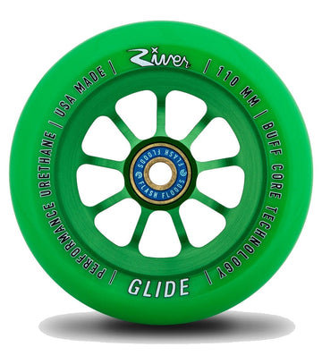 The Emerald Green River Glide 110mm Stunt Scooter Wheel boasts a spoked, anodised 6061-T6 aluminium core engraved with "Performance Urethane," "USA Made," "110 mm," and "Buff Core Technology." The blue central hub adds further branding, blending sleek design with premium craftsmanship.