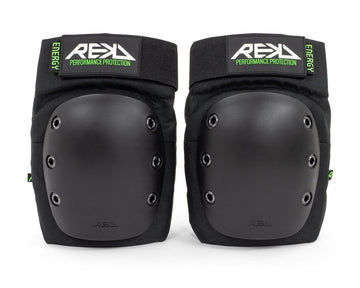 Introducing the REKD Energy Ramp Skate Protection Knee Pads - Black, designed with hard protective shells and impact foam for ultimate protection. These black knee pads offer adjustable straps for a snug fit and proudly feature "REKD" alongside "Performance Protection" on the bold green and black label.