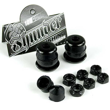 A set of Thunder Trucks Black Bushing Rebuild Kit - 100A showcasing high rebound urethane bushings. The image displays two sets of black bushings and eight black nuts on a white background, with Thunder's branded packaging featured in the background.