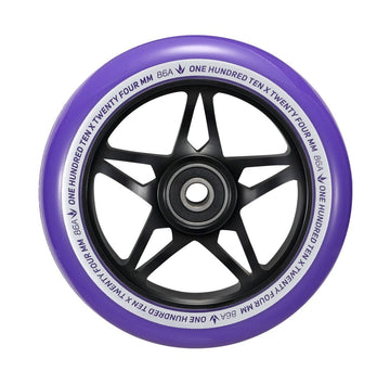 A close-up of a Blunt Envy One S3 110mm Stunt Scooter Wheel in black and purple showcases its black star-shaped inner rim. The edge is adorned with white text, reading "ONE HUNDRED TEN X TWENTY FOUR MM 86A." This wheel is constructed with durable 86A polyurethane and houses an ABEC 9 bearing at the center, ensuring optimal performance.